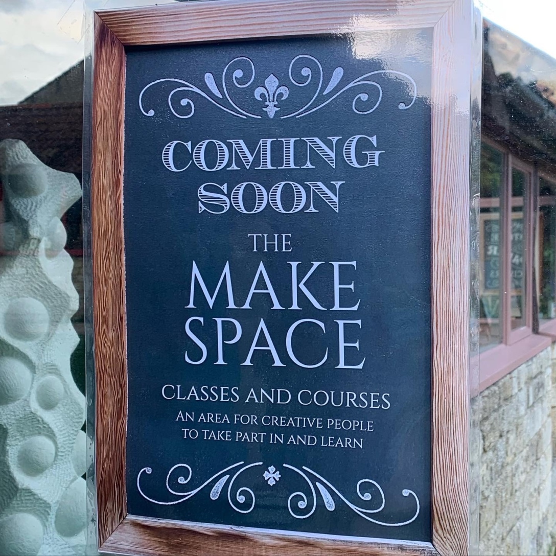 A framed chalkboard on which has been written 'Coming Soon. The Make Space. Classes and Courses. An area for creative people to take part in and learn.